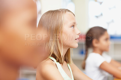 Buy stock photo Thinking, attention and kids in classroom for learning, growth and child development at elementary school. Group, lesson and students at desk for education, study or future opportunity in scholarship