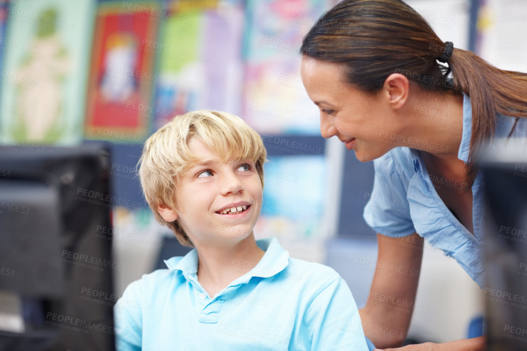 Buy stock photo Woman, educator and smile with boy on computer in classroom for help, teaching and learning. People, teacher and happy with student at elementary school for education, support and brain development