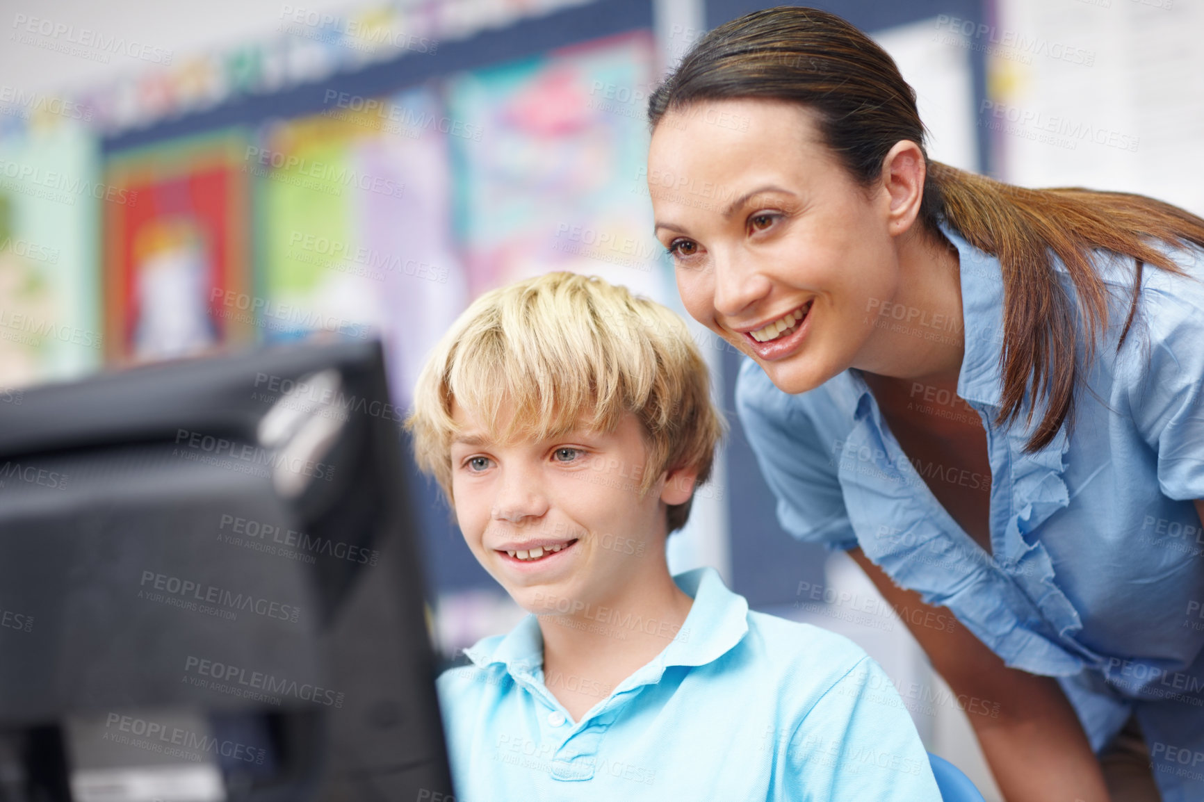 Buy stock photo Woman, educator and happy with boy on computer in classroom for help, teaching and learning. People, teacher and smile with student at elementary school for education, support and brain development