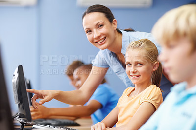 Buy stock photo Portrait of a beautiful young teacher assisting students in their computer class