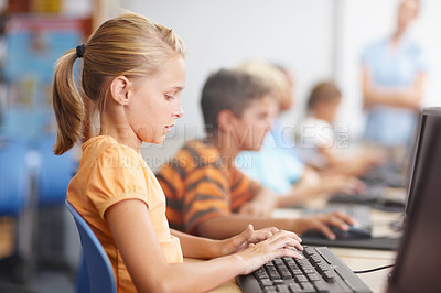 Buy stock photo A group of young children working hard in computer class