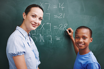 Buy stock photo Math, teacher and student portrait at chalkboard in classroom for solving number problem or answer question. Lesson, boy and writing solution for multiplication at school with scholarship or learning