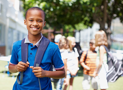Buy stock photo Handsome african-american boy standing outside with schoolmates in the backgound - copyspace