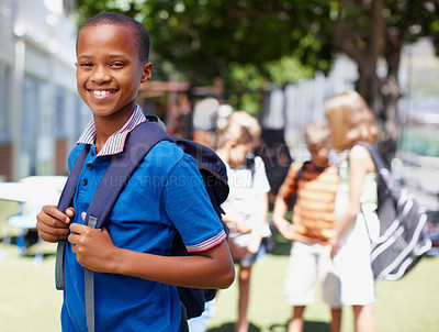 Buy stock photo Smiling african american boy posing outside with school friends in the background - copyspace