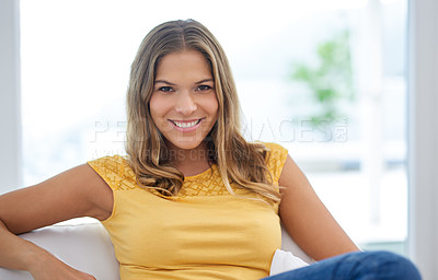 Buy stock photo Confident, portrait and happy woman in living room on sofa to relax in home or house for comfort or satisfaction. Face, smile and casual person in apartment on resting break for wellness in Spain