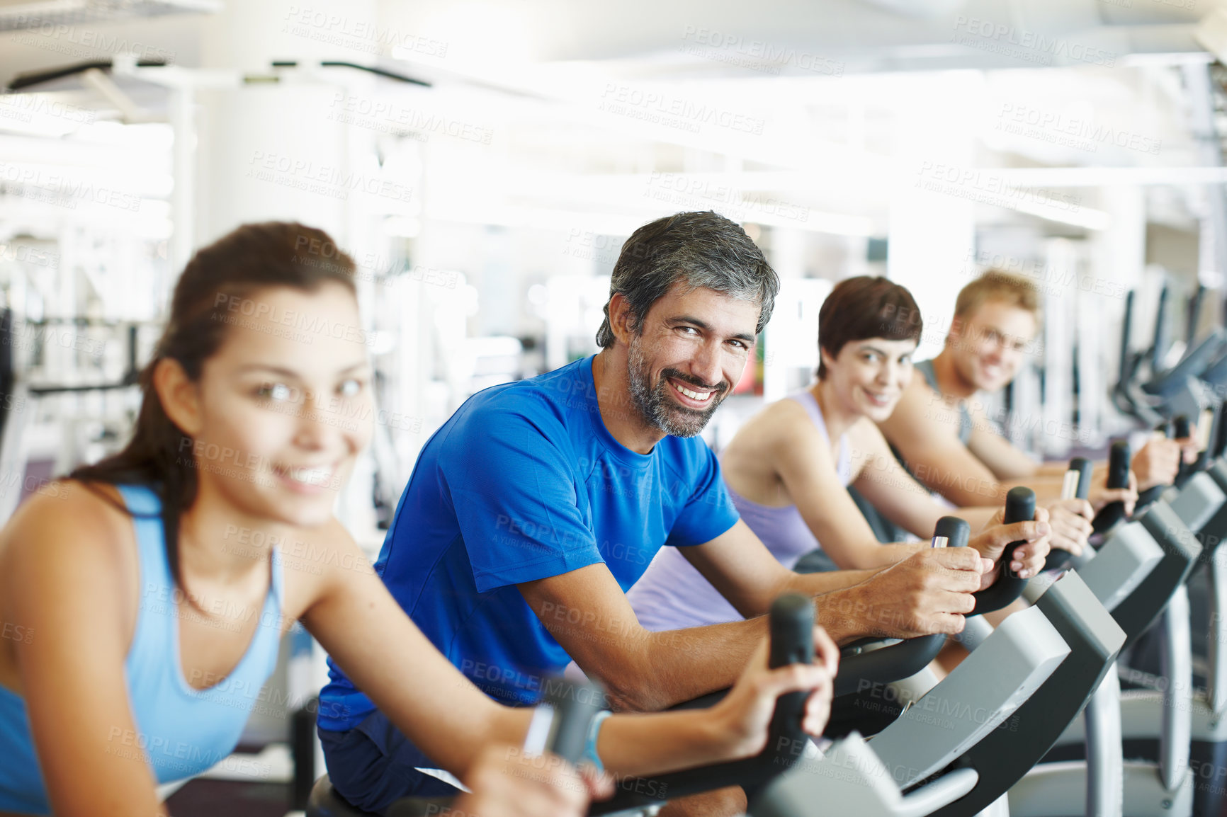 Buy stock photo Portrait, spin class or happy man cycling in training, gym and exercise for group, health or fitness. Smile, mature or people riding bicycle machine for cardio, strong legs or power for body workout