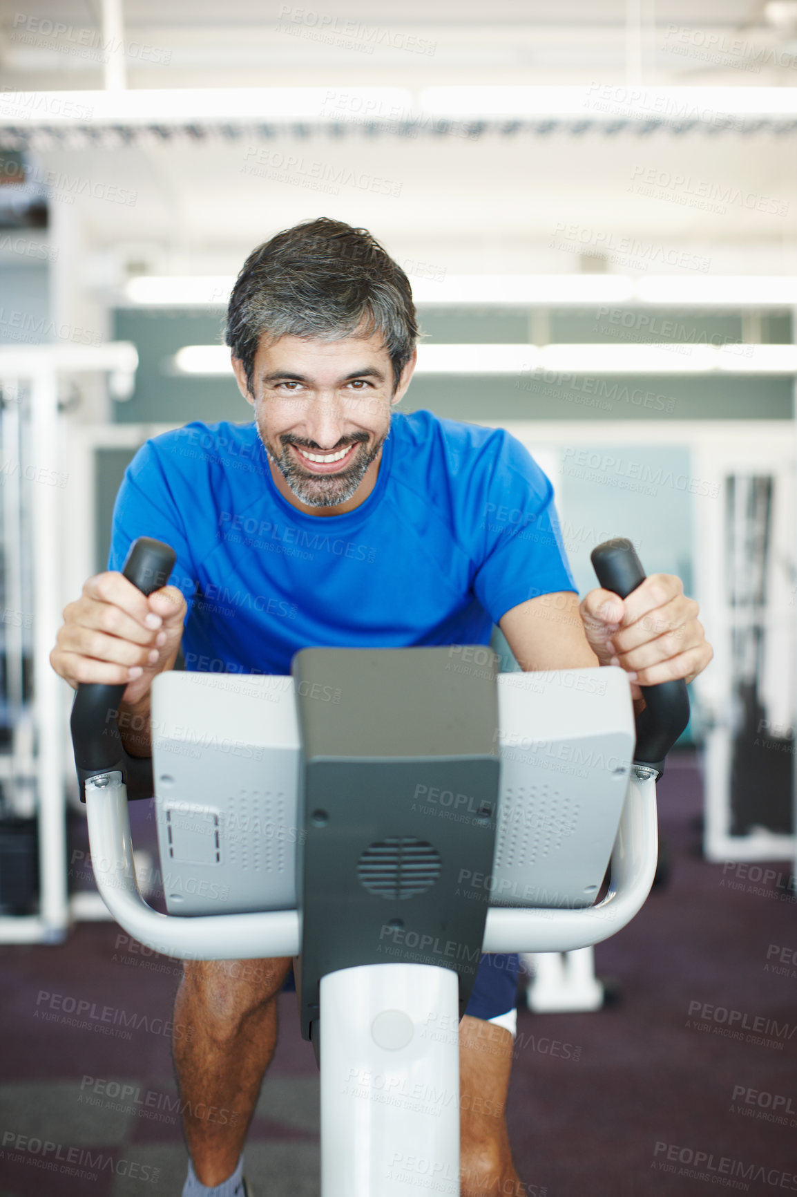 Buy stock photo Portrait, mature or happy man on cycling machine in gym, training and exercise for health or fitness. Smile, confident or healthy person riding bike for cardio, legs or power for body workout in USA