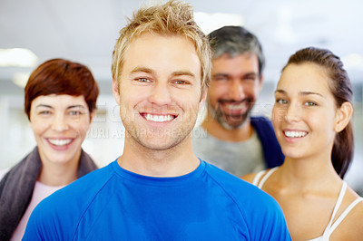 Buy stock photo Closeup portrait of handsome young man with his friends at fitness center