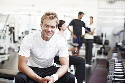 Buy stock photo Cropped shot of a handsome young man sitting in the gym