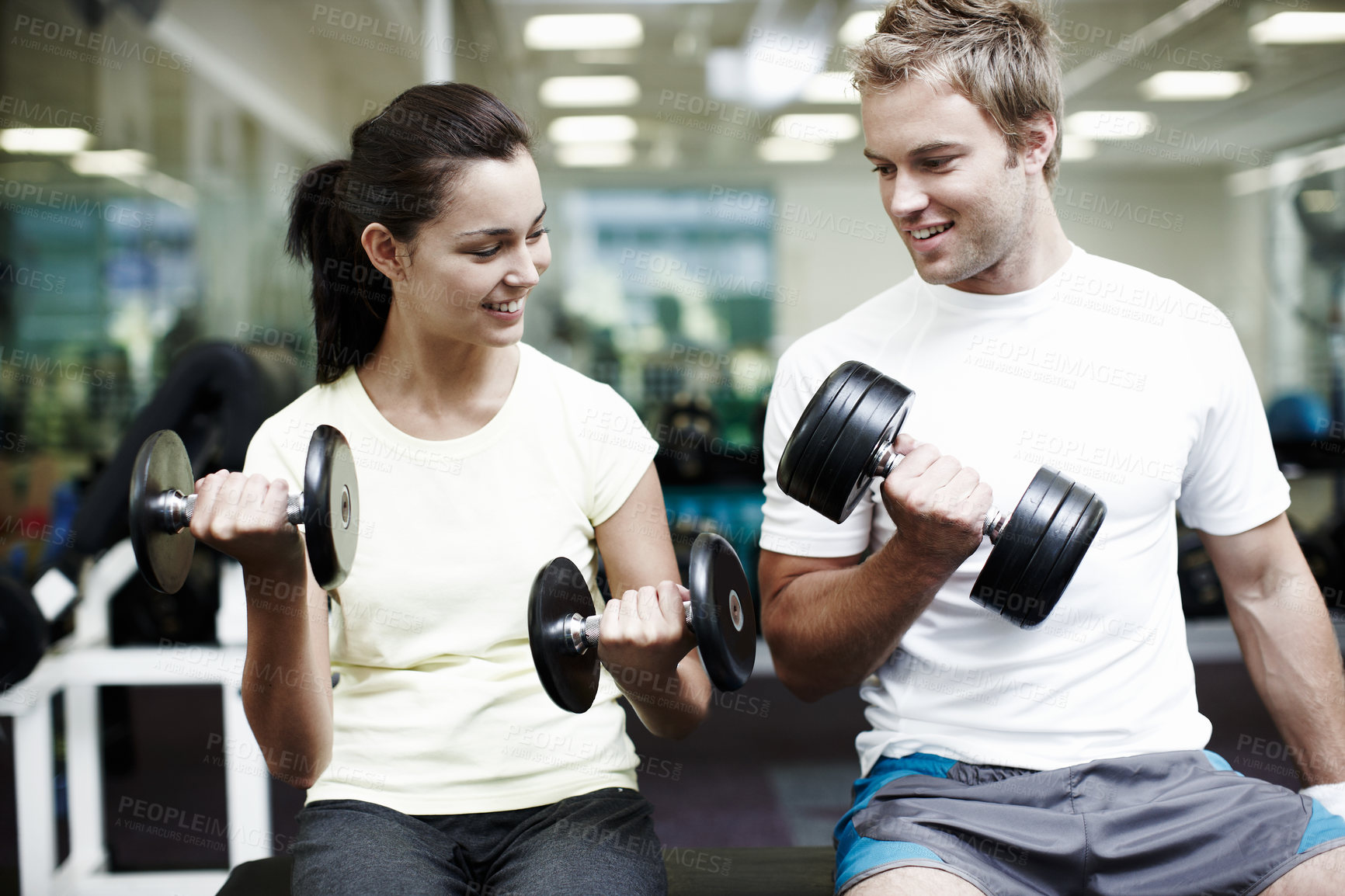 Buy stock photo Couple, smile and exercise with weights in gym for bodybuilding, fitness and training together. Man, woman and happy with equipment in health club for strength workout, support or teamwork in morning