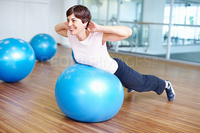 Buy stock photo Woman doing pilates ball exercise and smiling