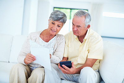 Buy stock photo Mature couple calculating domestic bills in living room