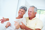 Cheerful mature couple discussing bills