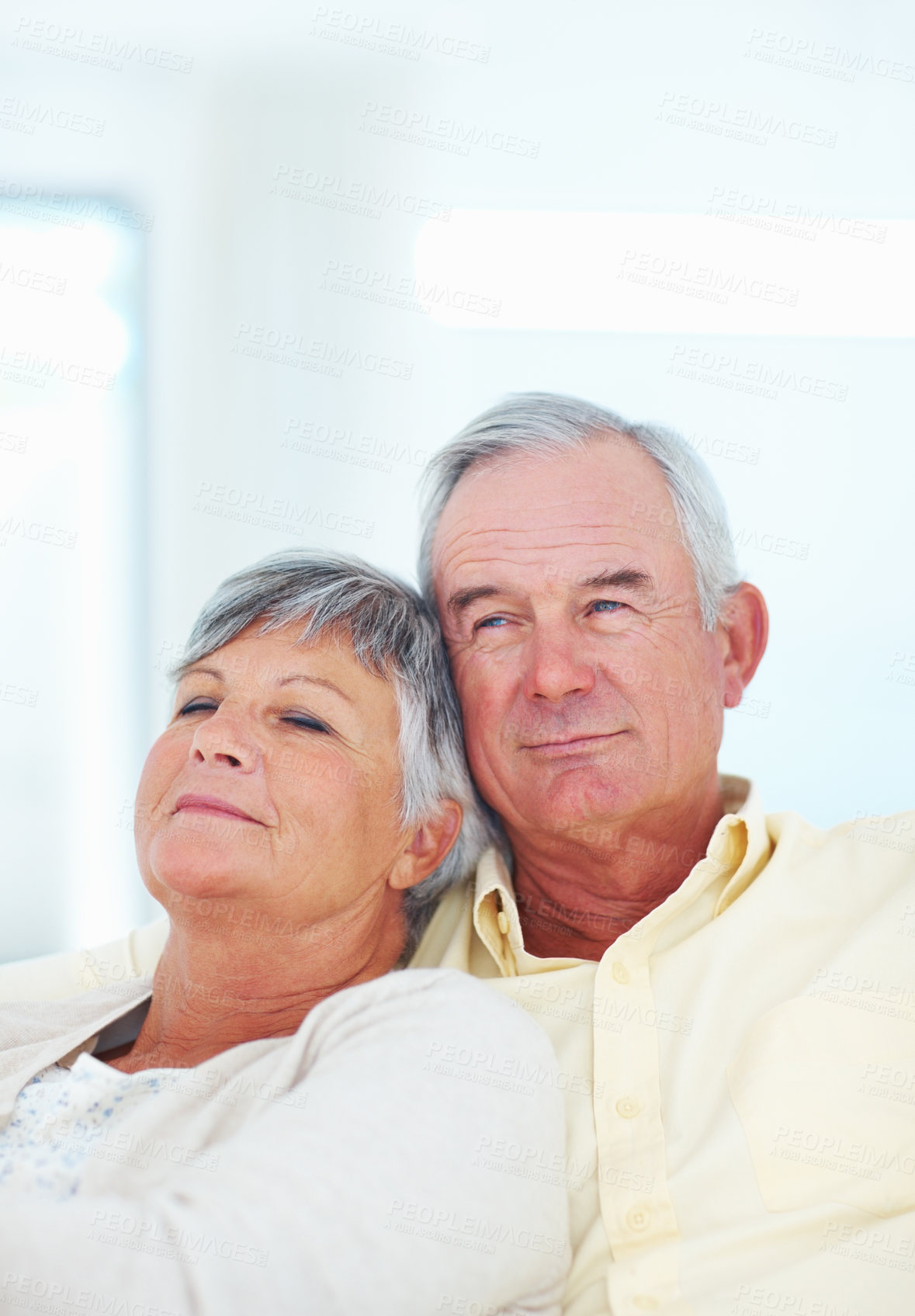 Buy stock photo Senior couple, care and hug in home, security and love in marriage connection on couch. Elderly people, embrace and commitment to relationship in retirement, bonding and support for comfort on sofa