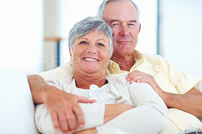 Buy stock photo Senior couple, portrait and love in home, safety and hug in marriage connection on couch. Elderly people, embrace and commitment to relationship in retirement, bonding and support for comfort on sofa