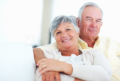 Buy stock photo Elderly couple, portrait and hug in home, trust and love in marriage connection on couch. Old people, embrace and commitment to relationship in retirement, bonding and support for comfort on sofa