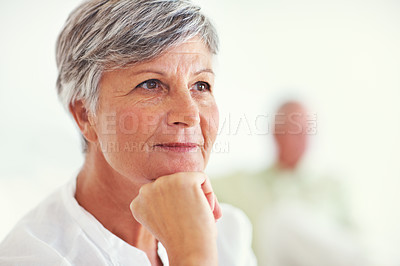 Buy stock photo Closeup of thoughtful mature woman thinking with blurred man in background