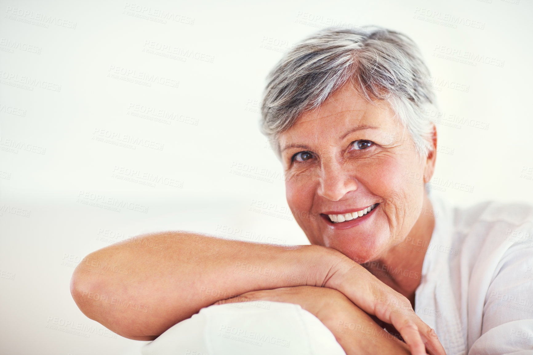 Buy stock photo Home, relax and senior woman in portrait for laughing, resting and enjoying in retirement on sofa. Mockup space, female person and confident with smile in living room, happy and positive attitude