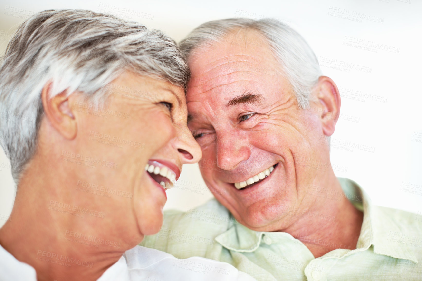 Buy stock photo Elderly couple, happy and laughing in home for relax, bonding and love with support, care and romance. Senior people, smile and connection in house for weekend break, marriage and embrace with trust