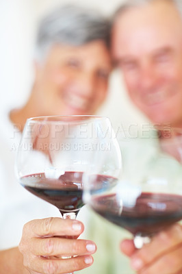 Buy stock photo Mature couple, hands and red wine with glass for alcohol tasting, celebration or date together at home. Closeup, elderly man and woman with drink or alcoholic beverage for holiday or bonding at house