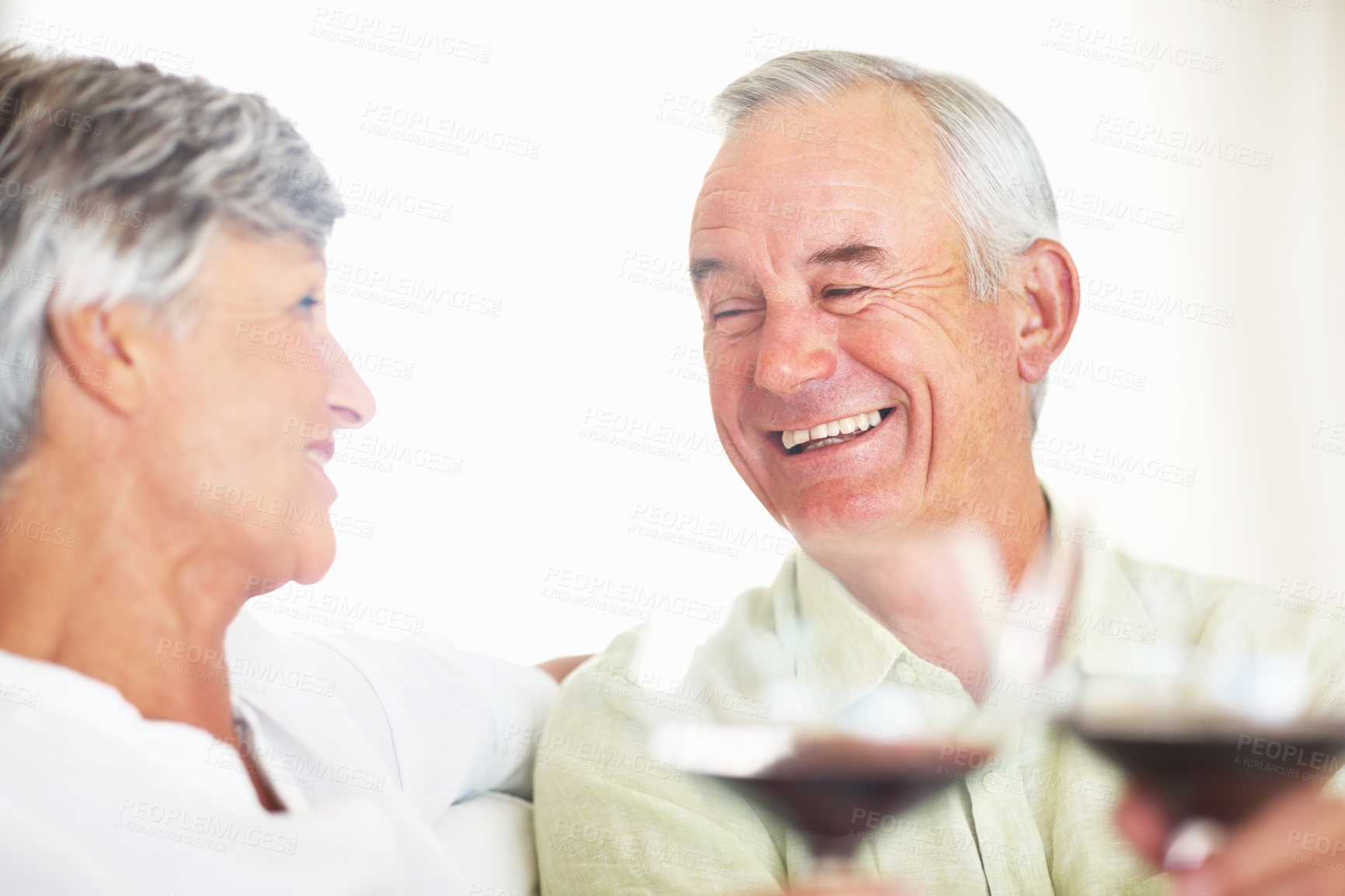 Buy stock photo Old couple, wine and laugh for toast in home, marriage anniversary and growth in partnership. Elderly people, romance and cheers with alcohol glasses for love celebration, milestone and bonding