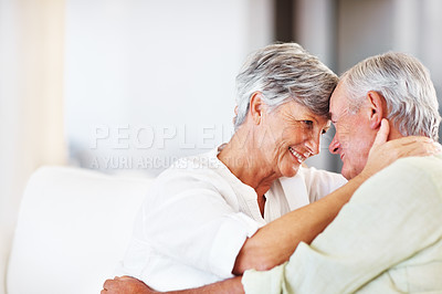 Buy stock photo Senior couple, embrace and romance in home for relax, bonding and love with support, care and together. Elderly people, smile and connection in house for weekend break, marriage and happy with trust