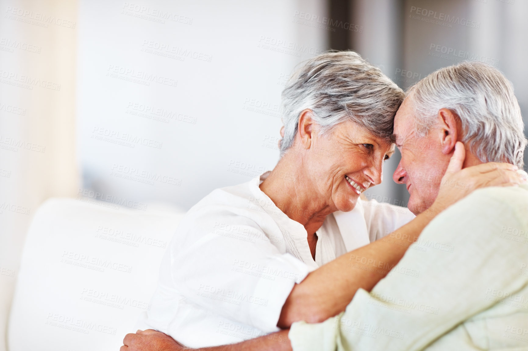 Buy stock photo Senior couple, embrace and romance in home for relax, bonding and love with support, care and together. Elderly people, smile and connection in house for weekend break, marriage and happy with trust