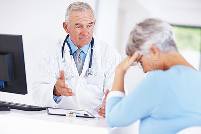 Buy stock photo Confident mature doctor discussing medical report with unhappy patient