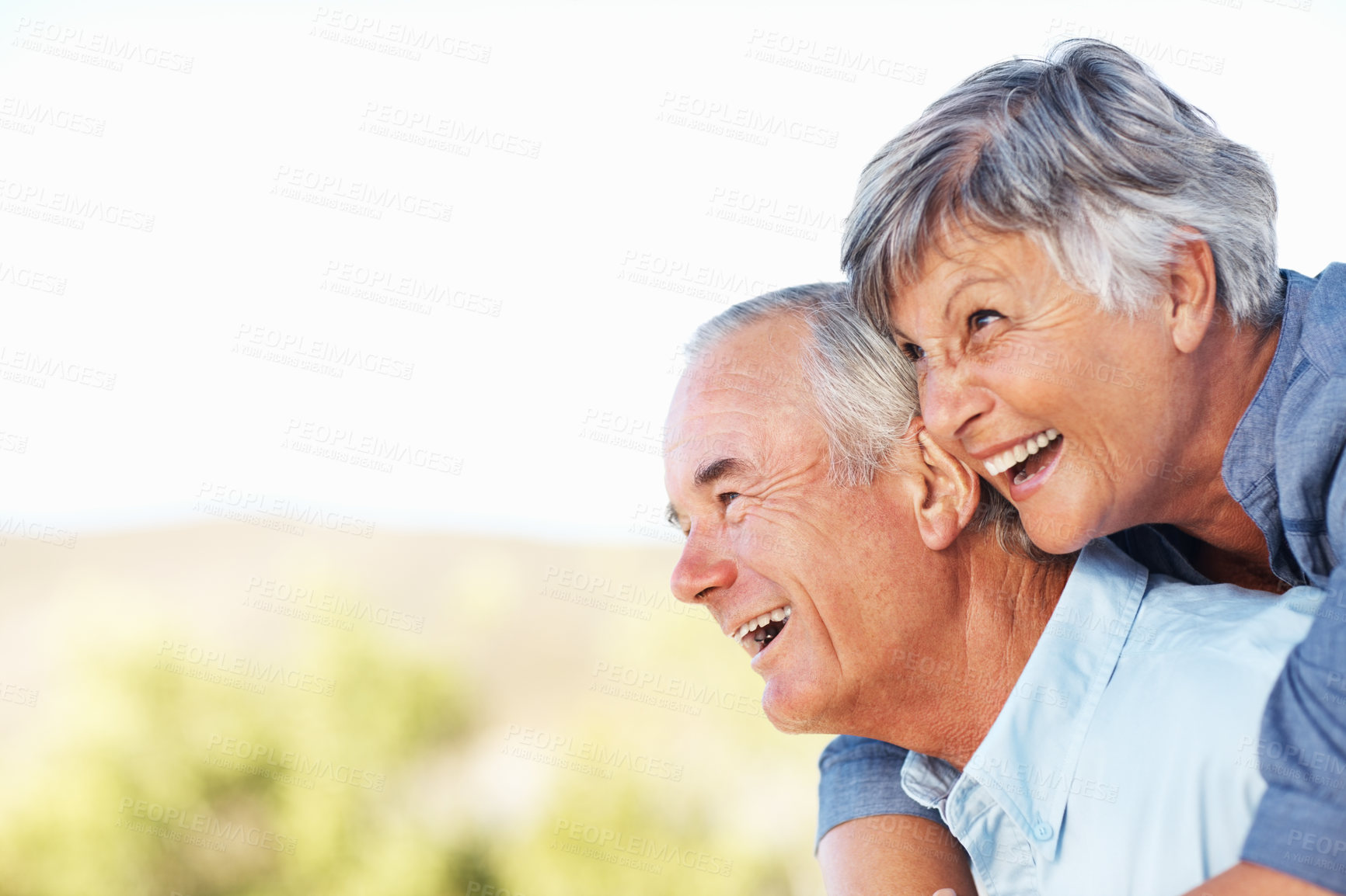 Buy stock photo Closeup of cheerful mature woman smiling while embracing man outdoors