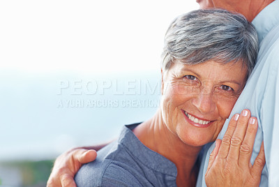 Buy stock photo Portrait of smiling mature woman leaning head against man's chest outdoors