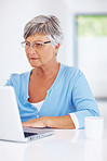 Mature woman using laptop at home