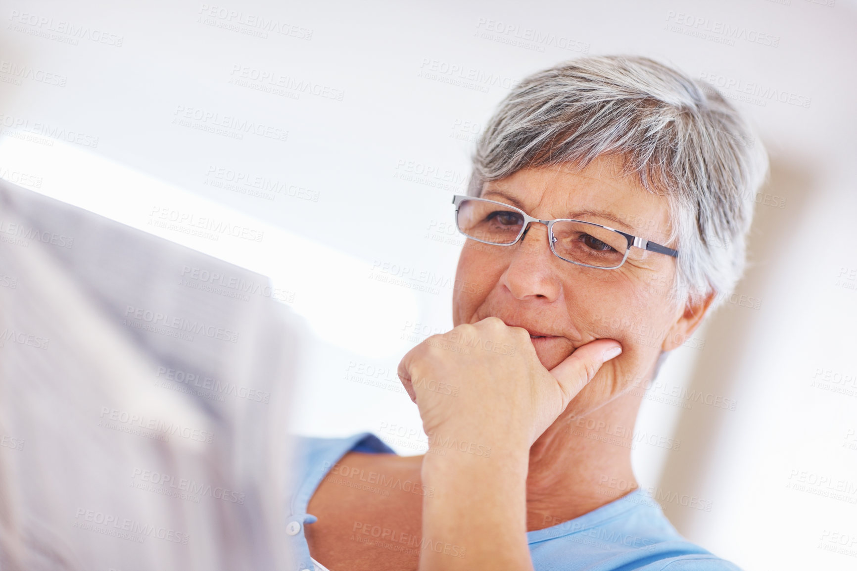 Buy stock photo Elderly woman, newspaper and thinking in home, headline announcement and relax in retirement. Female person, contemplating story and reading paper for information update, global event and print media