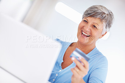 Buy stock photo Happy mature woman shopping online using laptop and credit card