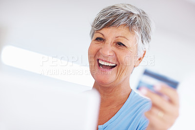 Buy stock photo Cheerful mature woman shopping online using credit card and laptop