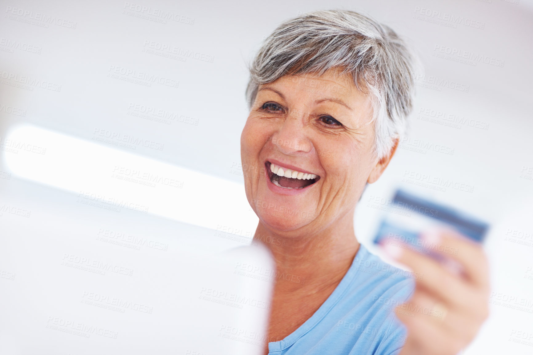 Buy stock photo Cheerful mature woman shopping online using credit card and laptop