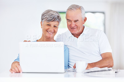 Buy stock photo Beautiful mature couple smiling while using laptop at home