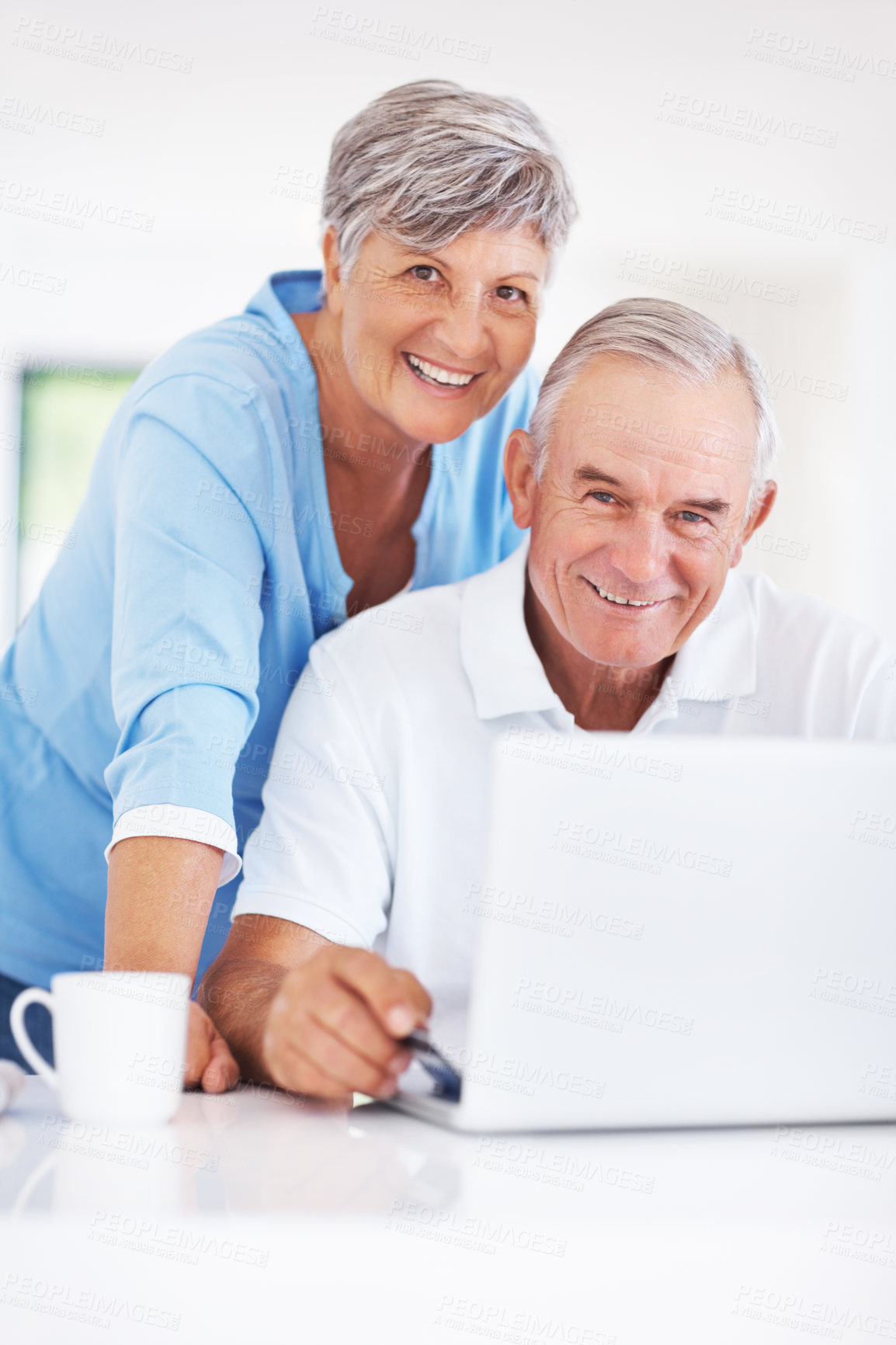 Buy stock photo Senior man, woman and portrait with laptop, smile and morning with reading, search or email in home. Happy couple, computer or elderly people in kitchen with notification, relax and coffee in Germany