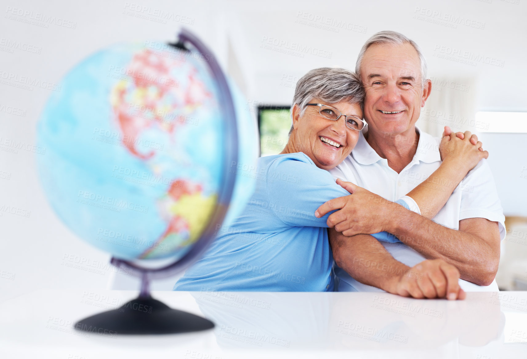 Buy stock photo Senior couple, globe or portrait in home with hug, commitment or excited for retirement travel. Elderly people, world map or happy in living room with love, milestone journey or trust in relationship