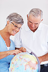 Couple searching travel destination on globe