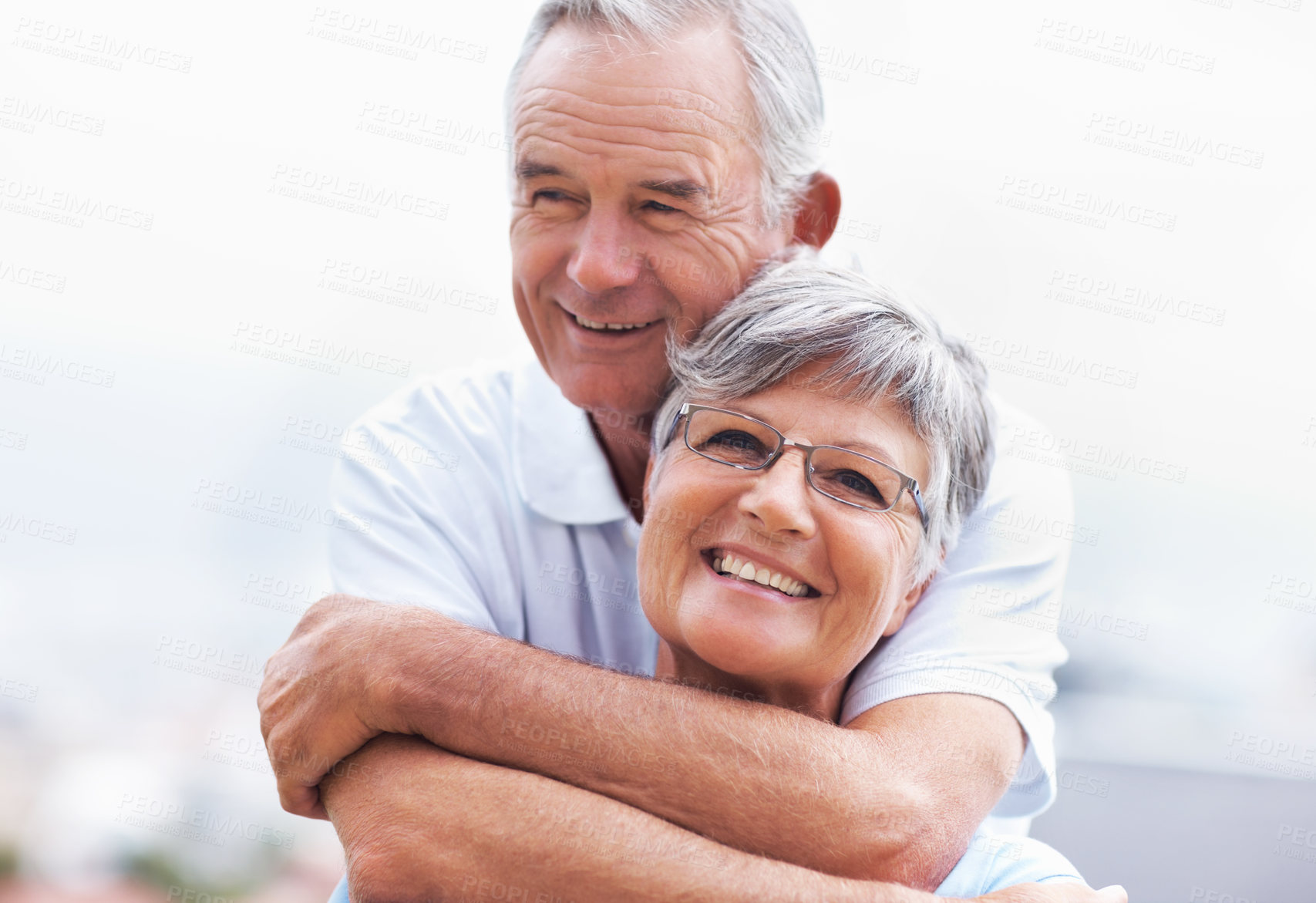 Buy stock photo Outdoor, elderly couple and smile with hug for love, connection and bonding together in retirement. Senior people, woman and man with embrace in marriage, commitment and security for care at home