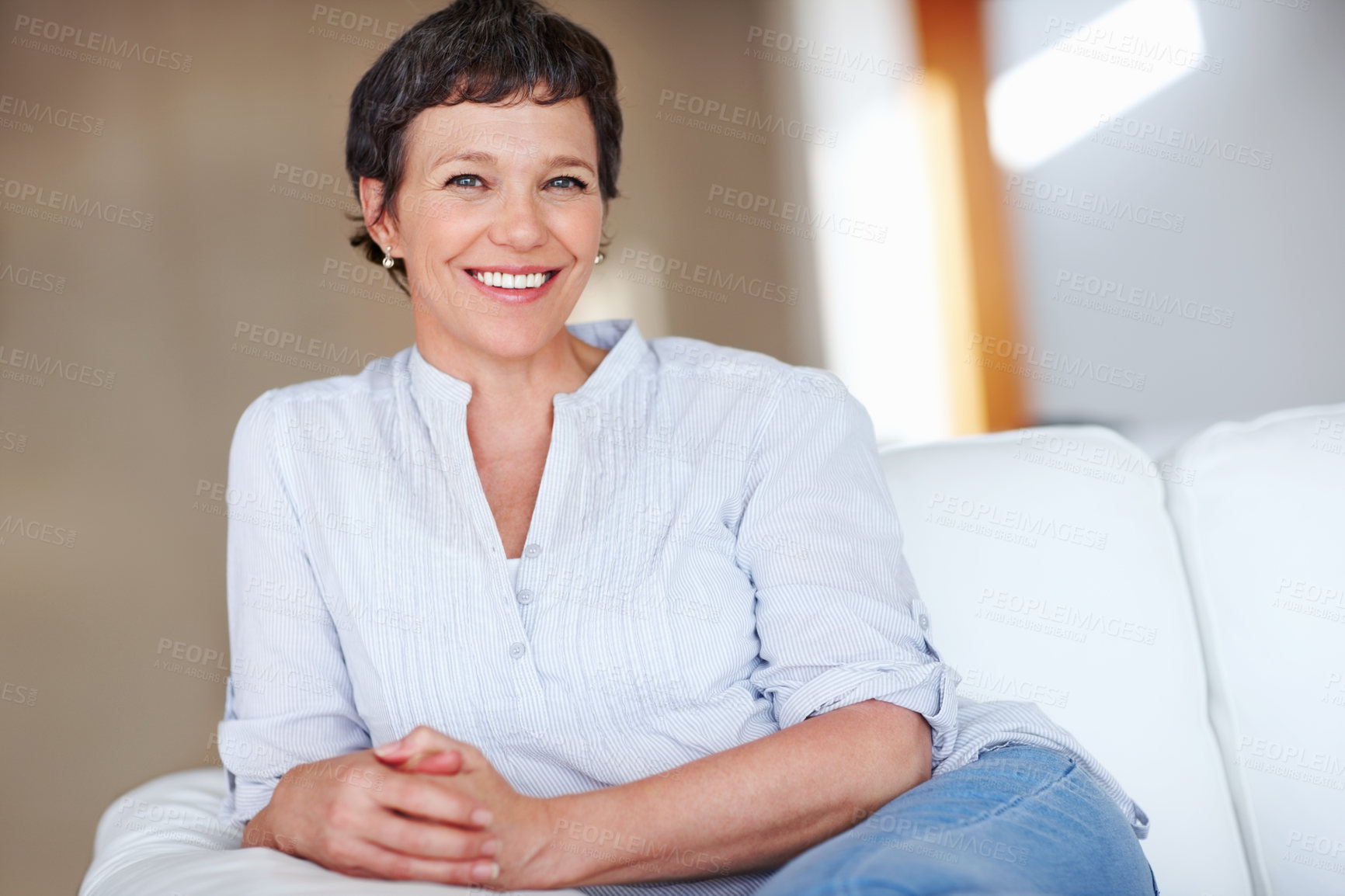 Buy stock photo Mature woman, smile and portrait in home on couch to relax with pride in lounge and living room. Real estate agent, confident or face of happy relator resting in France break, wellness or day off