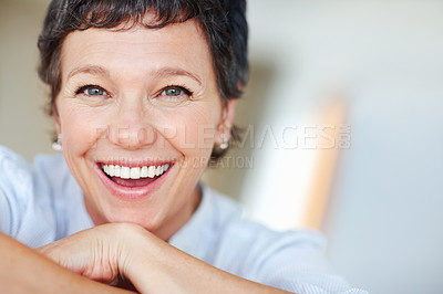 Buy stock photo Mature woman, laughing and portrait in home on couch to relax with pride in lounge for funny joke. Real estate agent, chill or face of happy female person resting in France break, wellness or day off