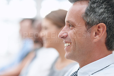 Buy stock photo Closeup of a businessman smiling as he attends a conference - Copyspace