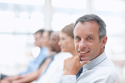Buy stock photo Portrait of a middle-aged businessman looking at you while in a meeting - Copyspace
