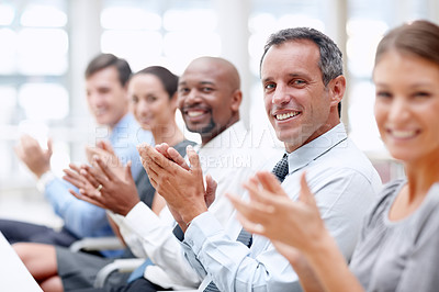Buy stock photo Happy row of business executives applaud while looking at you