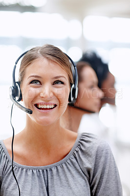 Buy stock photo Happy young businesswoman smiling while at work with her colleagues - Call operator