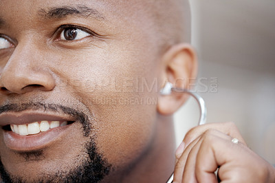 Buy stock photo Closeup of a friendly African-American doctor wearing a stethoscope looking out of frame