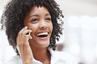 Buy stock photo A young ethnic woman talking on her cellphone