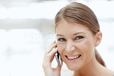 Buy stock photo Portrait of a beautiful young woman talking on her cellphone
