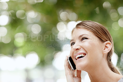 Buy stock photo A beautiful young woman speaking on her cellphone